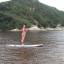 A Ana pratica standup paddle na lagoa da Guarda do Embaú, litoral sul de Santa Catarina